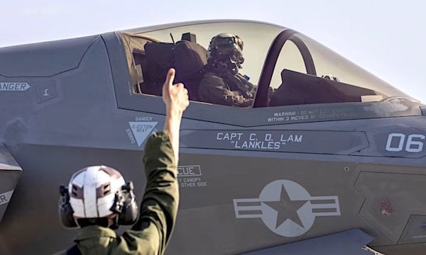 Marine Corps Lance Cpl. Austin Gardner, left, signals to Capt. Daniel Park before takeoff from Kadena Air Base, Japan, Thursday, April 4, 2025. (U.S. Marine Corps photo by Cpl. Chloe Johnson)
