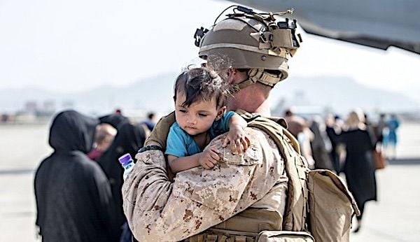 A Marine calms an infant during an evacuation at Hamid Karzai International Airport, Kabul, Afghanistan, Aug. 21, 2021. (U.S. Marine Corps photo by Sgt. Samuel Ruiz)