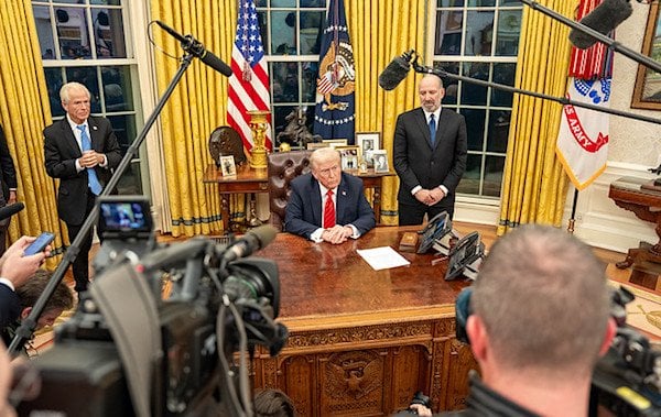 President Donald Trump signs executive orders, Monday, Feb. 10, 2025, in the Oval Office. (Official White House photo by Abe McNatt)