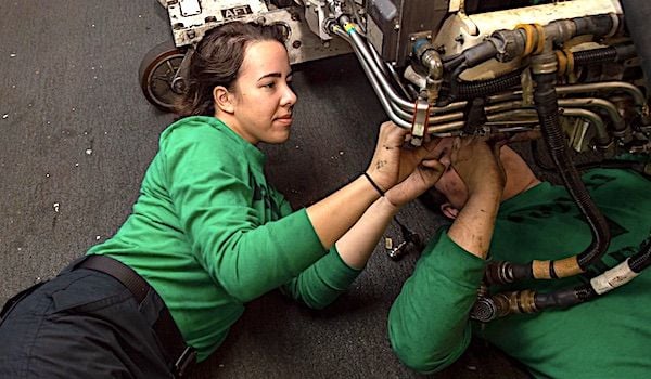 Aviation Machinist Mate 3rd Class Kaley Coustaut, left, from Orange County, California, and Aviation Machinist Mate 3rd Class Austin Mollard, from New Taipei, Taiwan, install a new wiring harness to an Air Refuling Store in the Hangar Bay of the Nimitz-class aircraft carrier USS Harry S. Truman, Dec. 6, 2021. (U.S. Navy photo by Mass Communication Specialist Seaman Hunter Day)