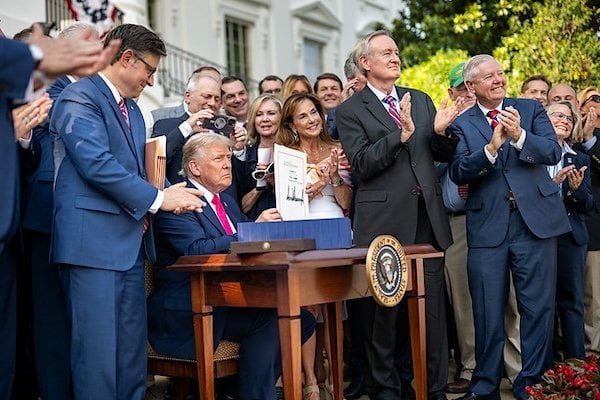 President Donald Trump signs the One Big Beautiful Bill Act on the South Lawn of the White House, Friday, July 4, 2025, during the 4th of July picnic. (Official White House photo by Daniel Torok)