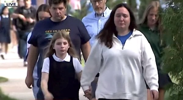Parents walk their children away from the shooting scene at Annunciation Church and School in Minneapolis, Minnesota, on Wednesday, Aug. 27, 2025 (Video screenshot)