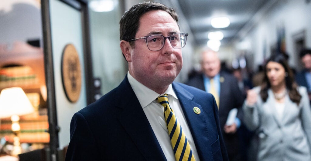 Mike Flood walks through the halls of the capitol