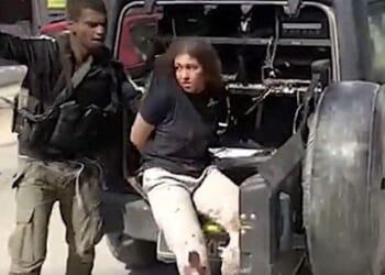 A Hamas terrorist takes a young Israeli woman hostage on Saturday, Oct. 7, 2023.