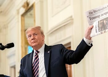 President Donald J. Trump shows a newspaper headline during his address Thursday, Feb. 6, 2020 in the East Room of the White House, in response to being acquitted in the U.S. Senate impeachment irial. (Official White House photo by D. Myles Cullen)