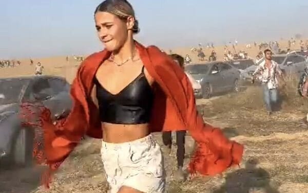 A young woman attending a concert in Israel flees as Hamas terrorists open fire on Saturday, Oct. 7, 2023 (Video screenshot)