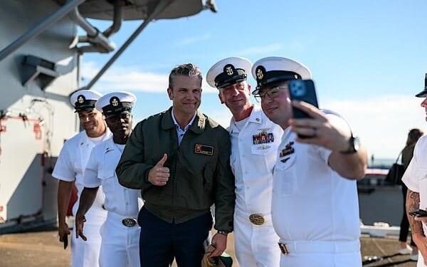 Secretary of War Pete Hegseth poses for photos with sailors before President Donald Trump delivers remarks at the U.S. Navy 250th anniversary celebration at Naval Station Norfolk in Norfolk, Virginia, Sunday, Oct. 5, 2025. (Official White House photo by Daniel Torok)