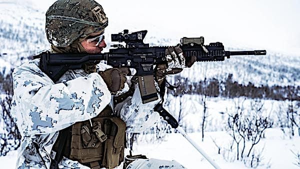 A Marine fires an automatic rifle during live-fire training for Exercise Reindeer II in Setermoen, Norway, Nov. 20, 2020. (U.S. Marine Corps photo by Cpl. William Chockey)