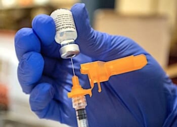 An Air Force medical technician draws a dose of the COVID-19 vaccine to inoculate Air Force reservists at Joint Base Lewis McChord, Washington, Sept. 12, 2021. (U.S. Air Force photo by Staff Sgt. Paolo Felicitas)