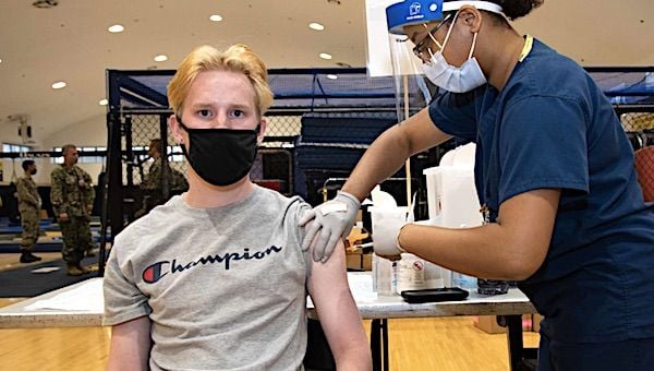 Judson Leary, a 16-year-old Kinnick High School student, receives his first dose of the Pfizer COVID-19 vaccine from Hospital Corpsman 1st Class Janasia Spotson during a vaccine distribution May 20, 2021, at Commander, Fleet Activities Yokosuka