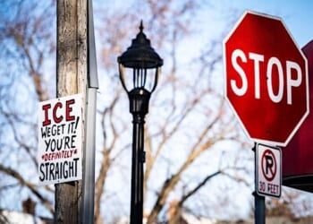 A sign up high on a Minneapolis utility pole that reads 'ICE WE GET IT! YOU'RE DEFINITELY STRAIGHT' on Monday, Jan. 26, 2026. (Photo by Chad Davis)