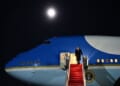 President Donald Trump disembarks Air Force One under a 97% waning gibbous moon, on Sunday, Jan. 4, 2026, at Joint Base Andrews, Maryland. (Official White House photo by Molly Riley)