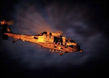 Coast Guardsmen, sailors and Marines take off in an MH-60S Sea Hawk helicopter ahead of a right of visit boarding in the Atlantic Ocean, Wednesday, Jan. 7, 2026. (U.S. Navy photo)