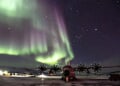 A LC-130 Skibird sits on the ramp at Kangerlussuaq Airport, Greenland, with the Northern Lights dazzling in the sky above, March 14, 2021. (Photo courtesy U.S. Air Force Lt. Col. Kevin Jones)