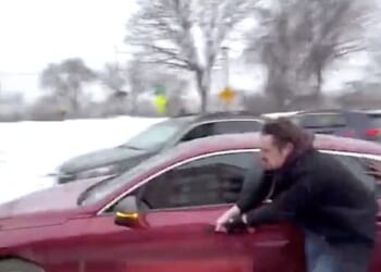 Journalist Nick Sortor gets his hand caught in a car door handle while trying to retrieve his stolen camera in Minneapolis on Sunday, Jan. 18, 2026 (Video screenshot)