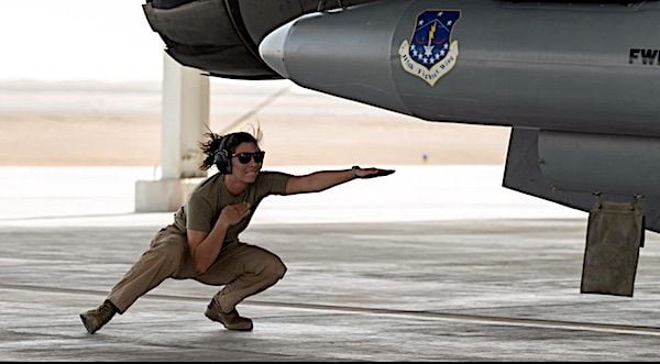Air Force Staff Sgt. Jami DeVries directs an F-16 Fighting Falcon during Operation Agile Spartan II at King Faisal Air Base, Saudi Arabia, March 9, 2022. (U.S. Air Force photo by Senior Airman Daniel Hernandez)