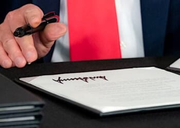 President Donald J. Trump signs a Presidential memorandum authorizing the other needs assistance program for major disaster declarations related to coronavirus disease Saturday, Aug. 8, 2020, at a news conference in Bedminster, New Jersey. (Official White House photo by Shealah Craighead)