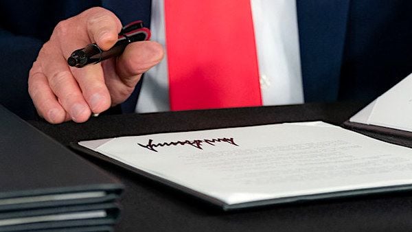 President Donald J. Trump signs a Presidential memorandum authorizing the other needs assistance program for major disaster declarations related to coronavirus disease Saturday, Aug. 8, 2020, at a news conference in Bedminster, New Jersey. (Official White House photo by Shealah Craighead)