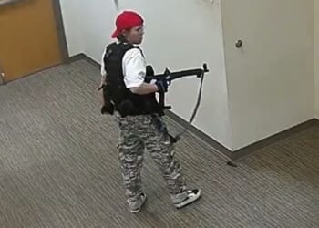 Transgender murderer Audrey Hale walks the halls of The Covenant School in Nashville, Tennessee, during her massacre.