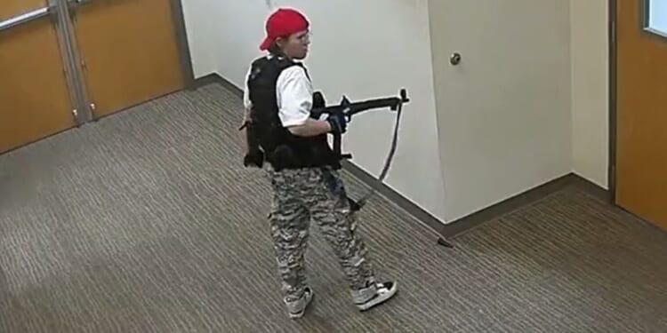 Transgender murderer Audrey Hale walks the halls of The Covenant School in Nashville, Tennessee, during her massacre.