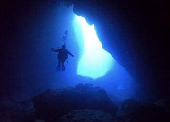 Master-at-Arms 2nd Class James Phelps from Indianapolis, Indiana, assigned to the submarine tender USS Frank Cable (AS 40), conducts a dive at the grotto on the island of Saipan, Commonwealth of the Northern Mariana Islands, Oct. 27, 2021. (U.S. Navy photo by Mass Communication Specialist 1st Class Jonathan B. Trejo)