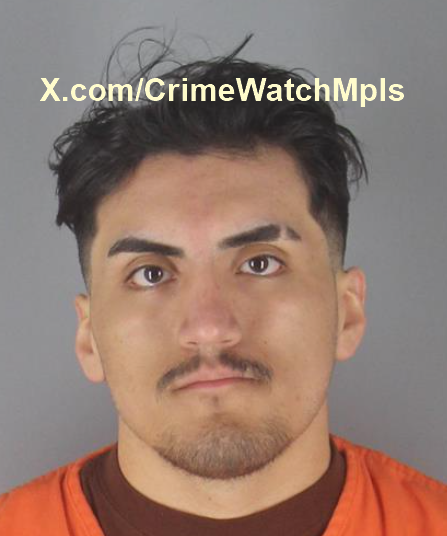 Mugshot of a man wearing an orange jumpsuit, with short dark hair and a neutral expression, highlighting a criminal investigation.