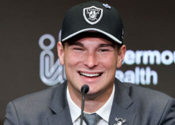 A close-up of a beaming Fernando Mendoza in a Las Vegas Raiders cap.