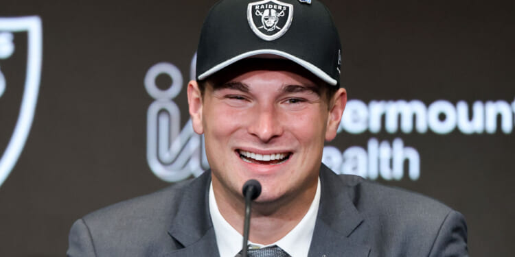 A close-up of a beaming Fernando Mendoza in a Las Vegas Raiders cap.