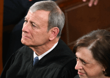 L/R) Supreme Court Chief Justice John Roberts and Supreme Court Justice Elena Kagan listen as US President Donald Trump delivers the State of the Union address in the House Chamber of the US Capitol in Washington, DC, on February 24, 2026. (Photo by Mandel NGAN / AFP via Getty Images)