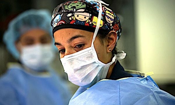 Lt. Cmdr. Marissa Mayor, a general surgeon with Fleet Surgical Team 7, observes her patient prior to conducting a surgical walkthrough during a mass casualty drill to assess skills and coordination between integrated units aboard the amphibious assault ship USS America in the Philippine Sea, June 18, 2021. (U.S. Marine Corps photo by Cpl. Karis Mattingly)