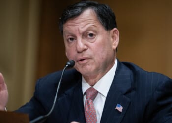 Frank Bisignano speaking into a microphone