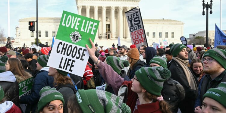 Pro-life protestors holding signs