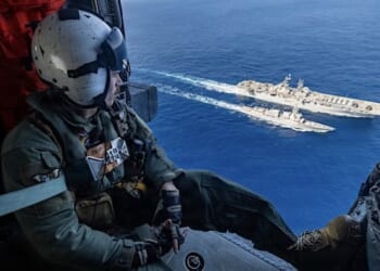 Navy Petty Officer 2nd Class Justin Baker observes as the USS Rafael Peralta receives fuel from the USS Tripoli during a replenishment in the Philippine Sea, Feb. 10, 2026. (U.S. Navy photo by Petty Officer 1st Class Ryre Arciaga)