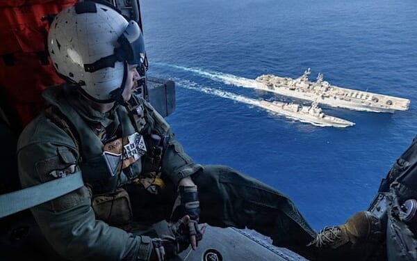 Navy Petty Officer 2nd Class Justin Baker observes as the USS Rafael Peralta receives fuel from the USS Tripoli during a replenishment in the Philippine Sea, Feb. 10, 2026. (U.S. Navy photo by Petty Officer 1st Class Ryre Arciaga)