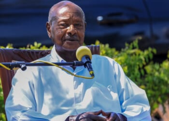 Yoweri Museveni speaking while seated