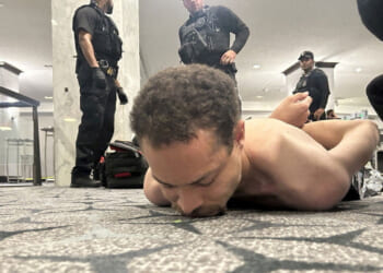 Law enforcement personnel detain Cole Tomas Allen, a suspect in the shooting incident at the White House Correspondents' Association dinner, in Washington