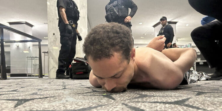 Law enforcement personnel detain Cole Tomas Allen, a suspect in the shooting incident at the White House Correspondents' Association dinner, in Washington