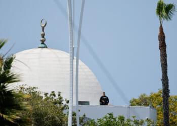 A police officer stands guard as emergency workers respond at the scene of a reported active shooter situation at the Islamic Center in San Diego, California, U.S., May 18, 2026. REUTERS/Mike Blake