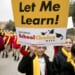 Child protester holding a sign that says "Let me learn! National School Choice Week"