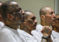 Prison inmates listen during a massive hearing against criminals and gang members at CECOT.