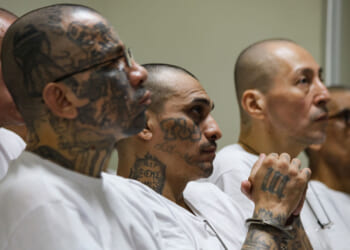 Prison inmates listen during a massive hearing against criminals and gang members at CECOT.