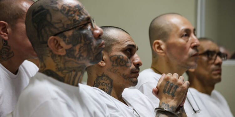 Prison inmates listen during a massive hearing against criminals and gang members at CECOT.