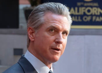 Close-up of Gavin Newsom looking up.