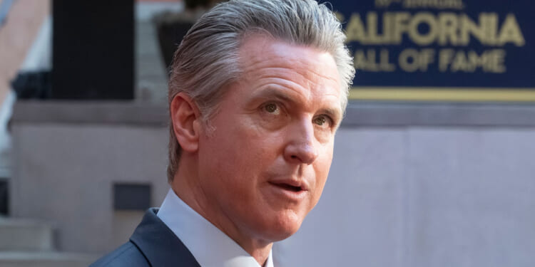 Close-up of Gavin Newsom looking up.