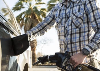 A man pumps gas.