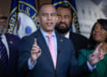 Hakeem Jeffries points upward during press conference with fellow Democrats.