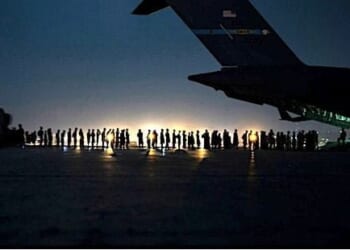 Airmen prepare to load qualified evacuees aboard a U.S. Air Force C-17 Globemaster III aircraft at Hamid Karzai International Airport, Kabul, Afghanistan, Aug. 21, 2021. (U.S. Air Force photo by Senior Airman Taylor Crul)