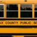 Side of a yellow Fairfax County Public Schools bus.