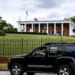 A demonstrator drives past the Governor's Mansion during a drive by protest in Atlanta, Georgia.