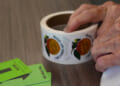 A woman tears stickers on Election Day.